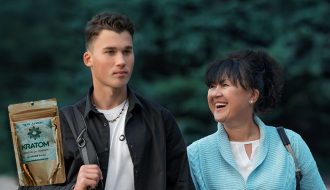 from left to right, kratom, son and mother smiling with trees behind them