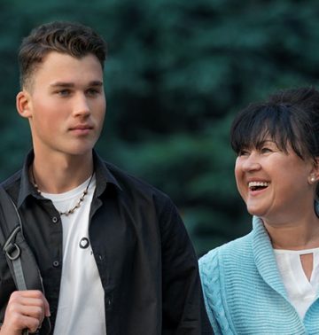 from left to right, kratom, son and mother smiling with trees behind them