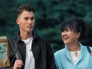 from left to right, kratom, son and mother smiling with trees behind them