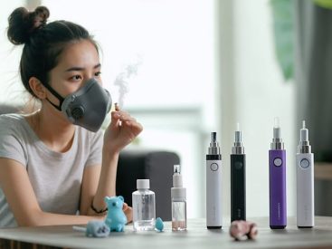 A concerned young mother holding a protective mask while examining vaping devices on a table, reflecting on indoor air quality and family health.